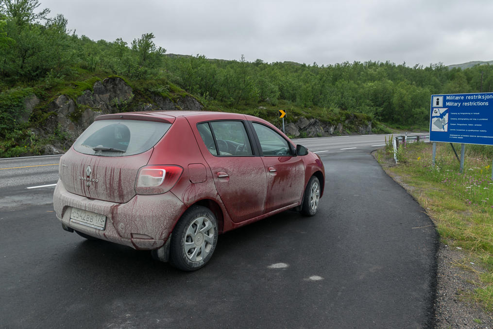 Car after driving on the road to Grense Jakobselv in wet weather, on the Route E6 near Kirkenes