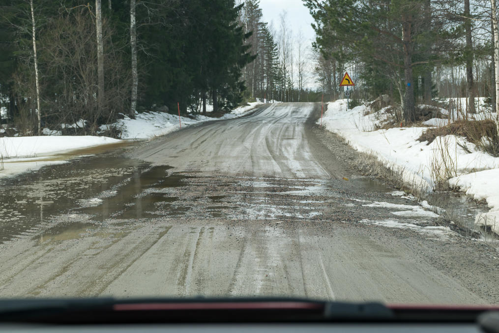 Minor gravel road slightly damaged by April rasputitsa in the vicinity of Mäntyharju village in South Savo