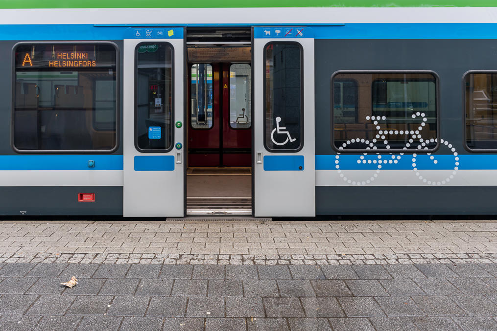 Commuter train with wheelchair 'step' extended.  (The doors are closing in the picture)