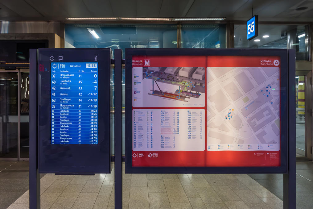 Bus display at Kamppi bus terminal. Bus terminal/metro station layout shown in 3D nearby